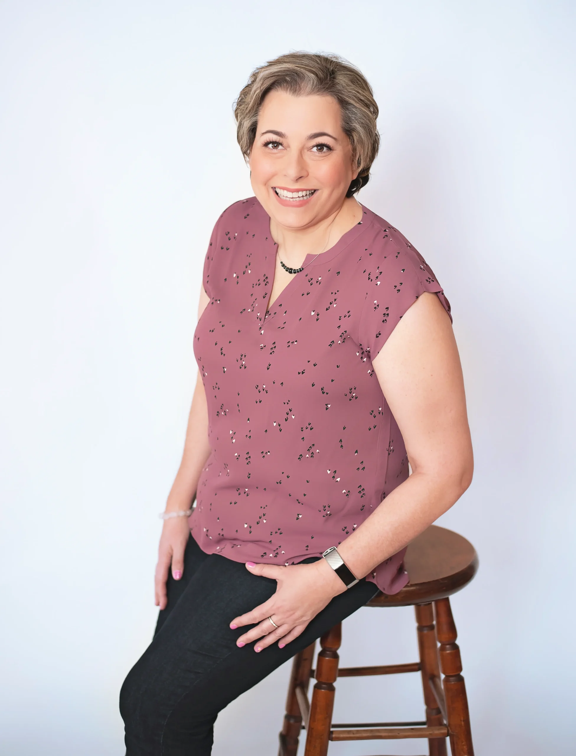 Judy of Clutter Relief Services sat on a stool, smiling at the camera