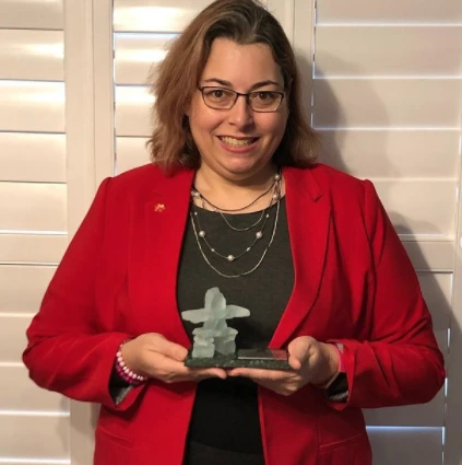 Judy Rickey posed holding the Taylor Harold Award, presented by the Professional Organizers of Canada